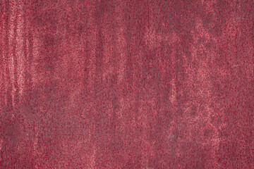 Fragment of a rusty grunge surface. Dark red background color. Scuffs and peeling of old paint....
