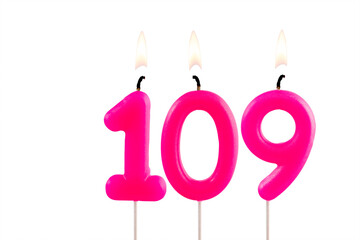 Pink number 109 birthday candle lit on white background