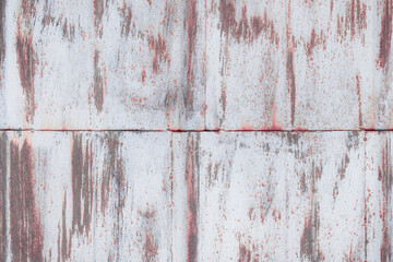 Fragment of a rusty grunge surface. White-brown background color. Scuffs and peeling of old paint....