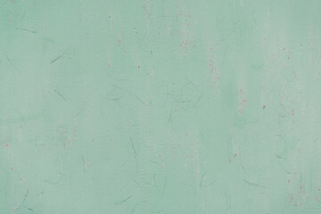 Naklejka premium Fragment of a rusty grunge surface. Orange-green background color. Scuffs and peeling of old paint. Scratches and traces of a welding seam.