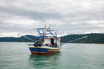 Fishing boat in Paraty Bay, a tourist town and World Heritage Site in Rio de Janeiro, Brazil