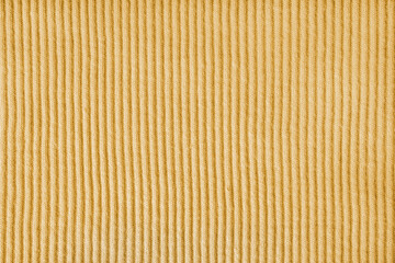 Fototapeta premium Jersey textile background , yellow striped ridge tricot fabric. Cotton stockinet, pullover surface texture, textile structure, cloth surface, weaving of knitwear material. Wallpaper, backdrop.