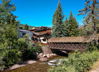 Wooden covered bridge over Gore Creek in Vail, Colorado. Gore Creek runs through Vail Village, an...
