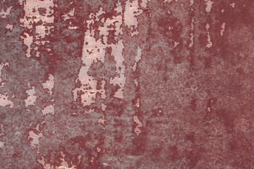 Fototapeta premium Fragment of a rusty grunge surface. Orange-brown background color. Scuffs and peeling of old paint. Scratches and traces of a welding seam.