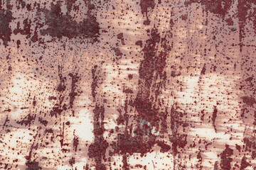 Fragment of a rusty grunge surface. Orange-brown background color. Scuffs and peeling of old paint. Scratches and traces of a welding seam.