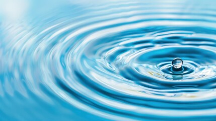 A closeup view of a water droplet initiating serene ripples against a calm blue backdrop, embodying peace and clarity.