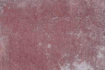 Fragment of a rusty grunge surface. Orange-brown background color. Scuffs and peeling of old paint. Scratches and traces of a welding seam.