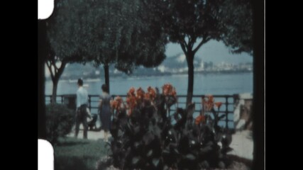 Arona Waterfront 1957 - A couple walks along the waterfront in Arona, Italy on the shore of Lake Maggiore, in 1957.