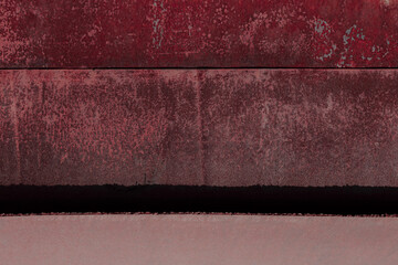 Fragment of a rusty grunge surface. Orange-brown background color. Scuffs and peeling of old paint....