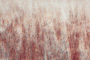 Fragment of a rusty grunge surface. Orange-brown background color. Scuffs and peeling of old paint....