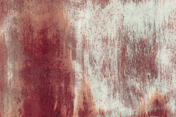 Fragment of a rusty grunge surface. Orange-brown background color. Scuffs and peeling of old paint. Scratches and traces of a welding seam.