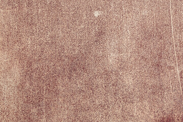 Fragment of a rusty grunge surface. Orange-brown background color. Scuffs and peeling of old paint....