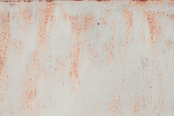 Fragment of a rusty grunge surface. Orange-brown background color. Scuffs and peeling of old paint....