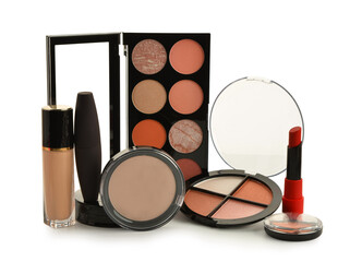 Different new makeup products on white background