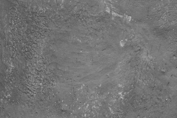 Monochrome texture of a concrete wall with natural relief and damage in the form of chips and...