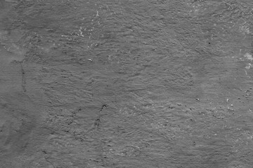 Monochrome texture of a concrete wall with natural relief and damage in the form of chips and...