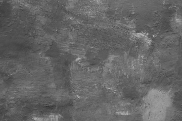 Monochrome texture of a concrete wall with natural relief and damage in the form of chips and...