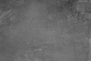 Naklejka premium Monochrome texture of a concrete wall with natural relief and damage in the form of chips and scratches. Fragment of an old stone surface with a crack. Dark rough surface with a place for an inscripti