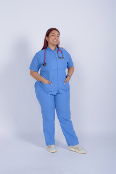 happy Female paramedic posing standing on white background, studio shot.