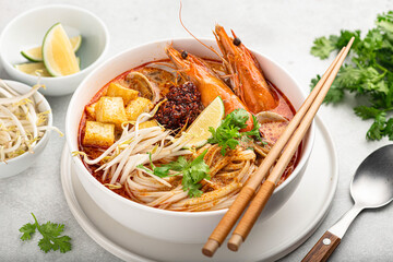 Laksa noodle soup with shrimp, tofu and sprouts, selective focus