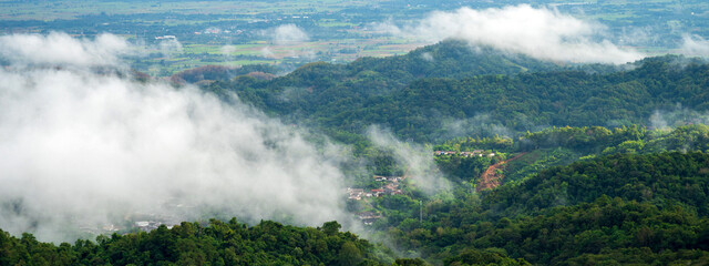 Banner Beautiful Mountain landscape foggy mountain green landscape morning sunrise. Amazing Landscape mountain green tropical forest tree on sunrise. Banner forest sunlight scenery with copy space