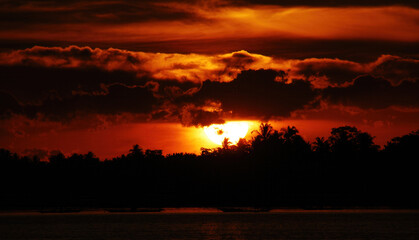Dramatic sunset over mountain landscape. Beautiful landscape foggy hills twilight time. Blue golden sky sunrise dramatic beautiful landscape mountain. Dawn sky gold dusk time cloudscape with sunlight