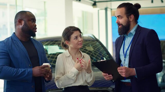 Car dealership salesman inviting customers to conduct test drives to demonstrate vehicle capabilities. Showroom agent suggesting clients optional equipment to purchase, camera A