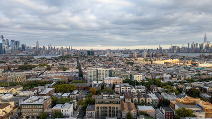 Wide aerial view capturing the neighborhoods of Hoboken and Jersey City, with the iconic New York...