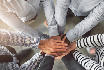 Above, business people and hands with stack for partnership, support and integration in office. Top...