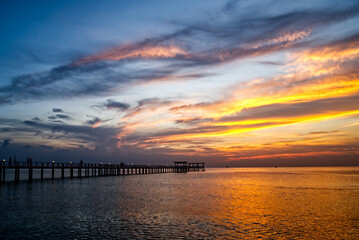 landscape,The beautiful yellow sky in the evening after sunset reflects the sea and the bridge. 