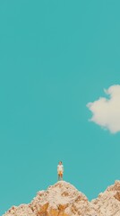 Obraz premium Man Standing on Top of Mountain with Blue Sky and Cloud