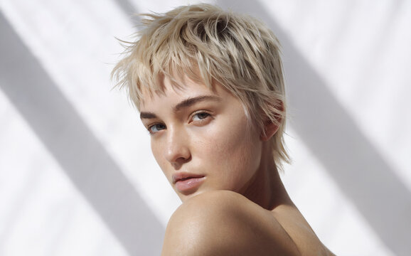 Choppy Pixie Cut: A fresh and airy close-up shot of a face, emphasizing the hairstyle, showcases a choppy pixie cut that adds texture and dimension, perfectly framing her features