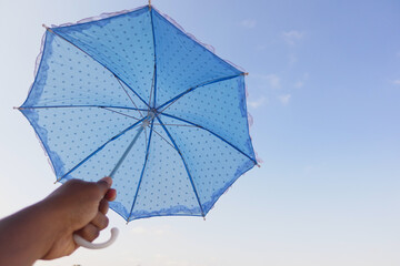 A Bright Blue Polka Dot Umbrella Set Against a Beautifully Clear and Clear Sky Above, Glowing