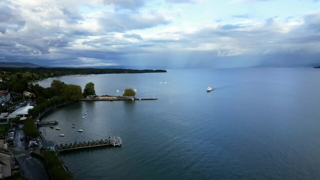 Push in drone shot of boat arriving at Nyon Port on Lake Geneva in Switzerland