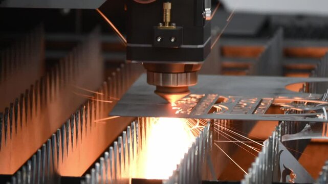 Pan scene the fiber laser cutting machine  cut the metal plate with the sparkling light.