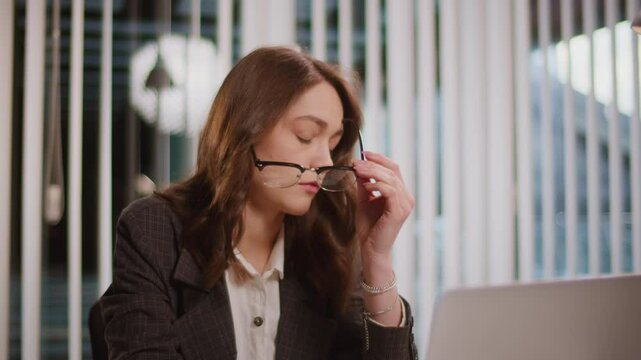A Businesswoman Feels Fatigue Working on a Computer in a Modern Office. Highlighting the Importance of a Flexible Work Schedule and Recovery Resources to Combat Fatigue. Stress Management Needed.