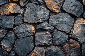 Fototapeta premium Close-up of a Rough Stone Wall with Irregularly Shaped Stones