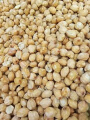 Vertical photo of a group of whole candlenuts for the background