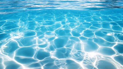 75.A mesmerizing view of crystal-clear blue water, with gentle ripples shimmering under the bright sunlight. The water's clarity reveals the sandy bottom beneath, creating an inviting and refreshing