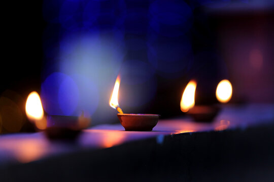 A radiant Diwali diya flickers brightly, symbolizing hope, joy, and the triumph of light over darkness.