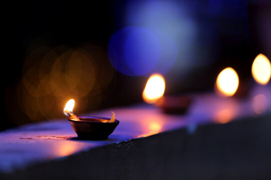 A radiant Diwali diya flickers brightly, symbolizing hope, joy, and the triumph of light over darkness.