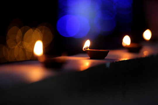 A radiant Diwali diya flickers brightly, symbolizing hope, joy, and the triumph of light over darkness.