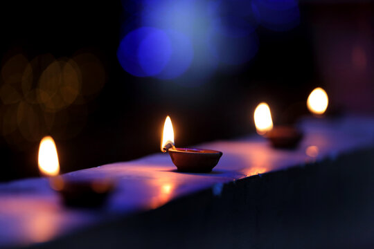 A radiant Diwali diya flickers brightly, symbolizing hope, joy, and the triumph of light over darkness.