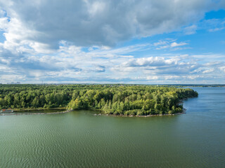 Fototapeta premium Aerial view of lake or river green shore with forest. Summer season.