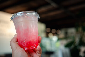 Strawberry Italian soda with ice on hand