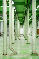The abandoned industrial structure stands as a relic of the past, its steel frame and glass windows reflecting the city's urban transformation