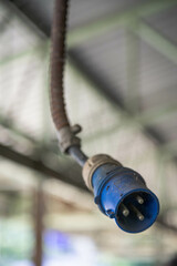 An old power plug with a lot of dust and rust.