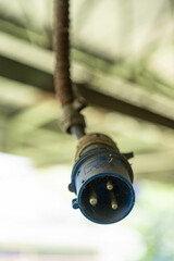 An old power plug with a lot of dust and rust.