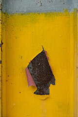 The paint on the steel structure is peeling off, revealing the rust inside.
