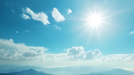 Obraz premium A Bright Sun Over a Blue Sky and Hazy Mountains
